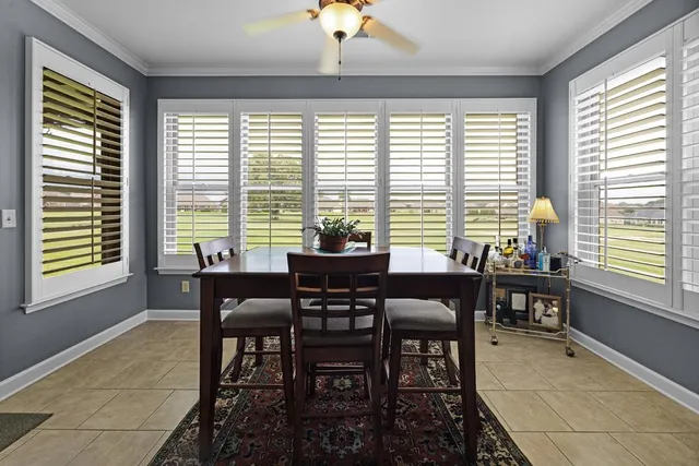 a view of a dining room with furniture window and outside view