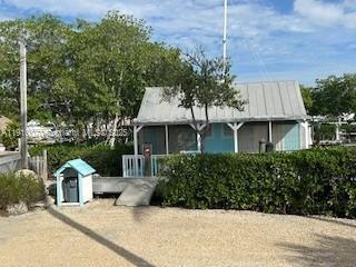 100 Morr Ln C5 Key Largo, FL 33037 - Photo 13 of 21 a front view of a house with a garden