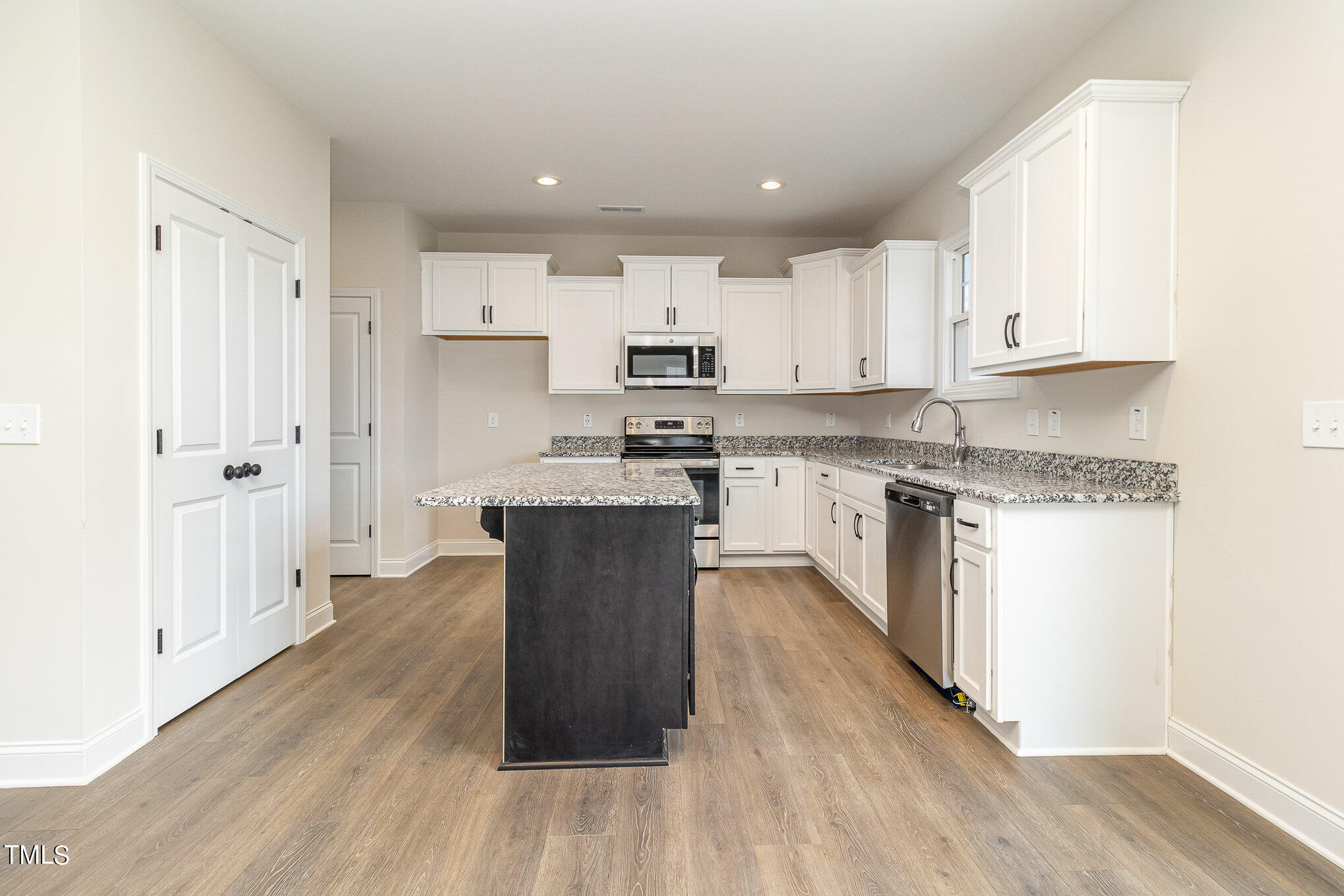 299 Jackson Pond Drive Smithfield, NC 27577 - Photo 13 of 25 a kitchen with stainless steel appliances granite countertop a stove a sink dishwasher and a refrigerator with wooden floor