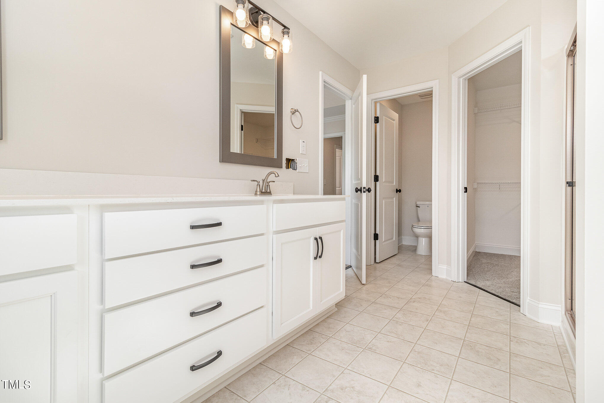 299 Jackson Pond Drive Smithfield, NC 27577 - Photo 19 of 25 a spacious bathroom with a double vanity sink a mirror and a shower