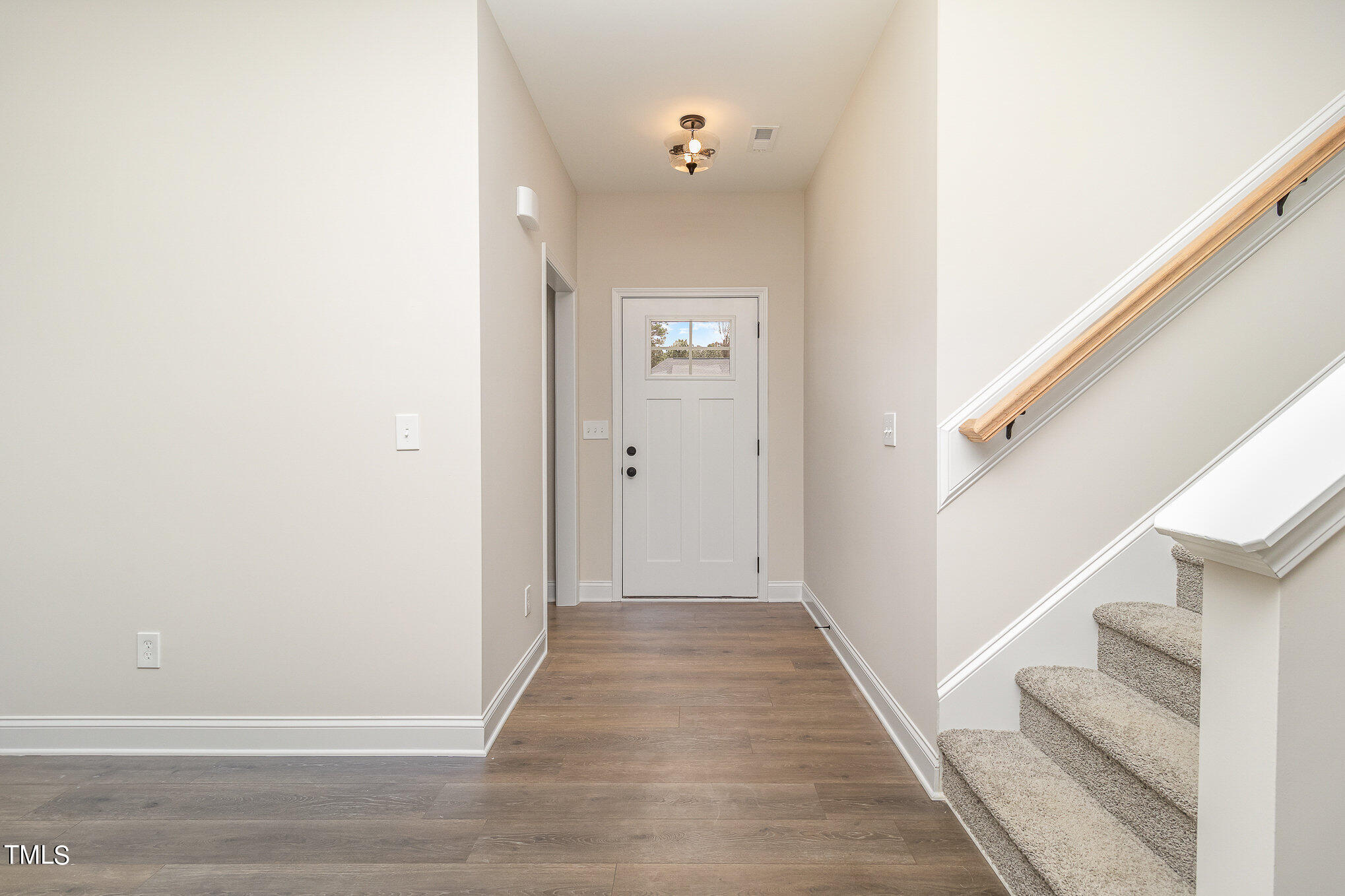299 Jackson Pond Drive Smithfield, NC 27577 - Photo 5 of 25 a view of a hallway with wooden floor and staircase