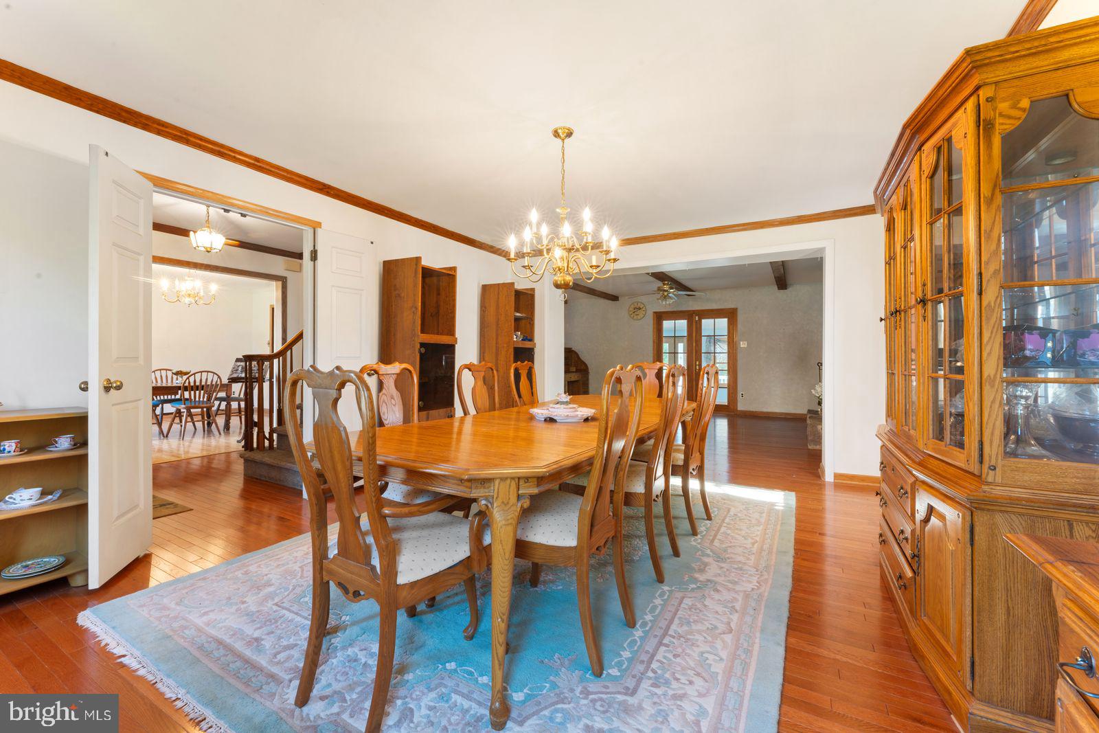 2015 Butternut Drive Huntingdon Valley, PA 19006 - Photo 13 of 40 a dining room with wooden floor a chandelier a wooden table and chairs