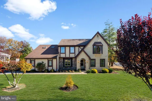 a front view of a house with yard and green space