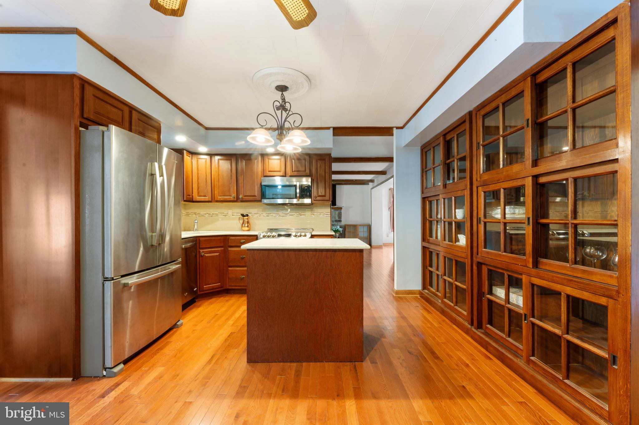 2015 Butternut Drive Huntingdon Valley, PA 19006 - Photo 22 of 40 a kitchen with stainless steel appliances granite countertop a refrigerator a sink dishwasher a stove and a dining table with wooden floor