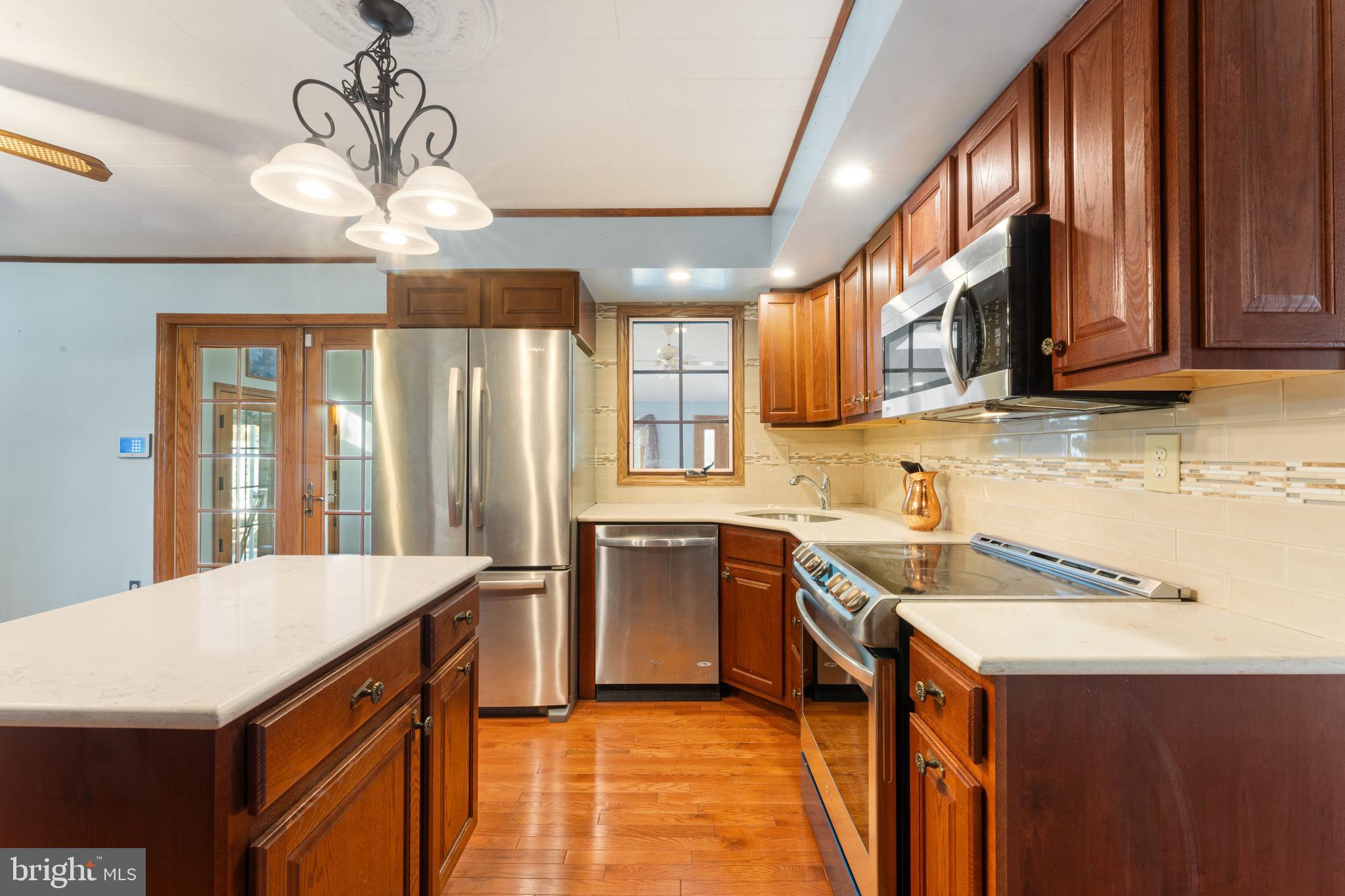 2015 Butternut Drive Huntingdon Valley, PA 19006 - Photo 23 of 40 a kitchen with stainless steel appliances granite countertop a sink a stove cabinets counter space and a window