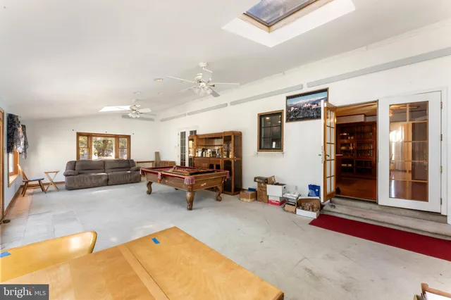 a living room with furniture gym equipment and a large window