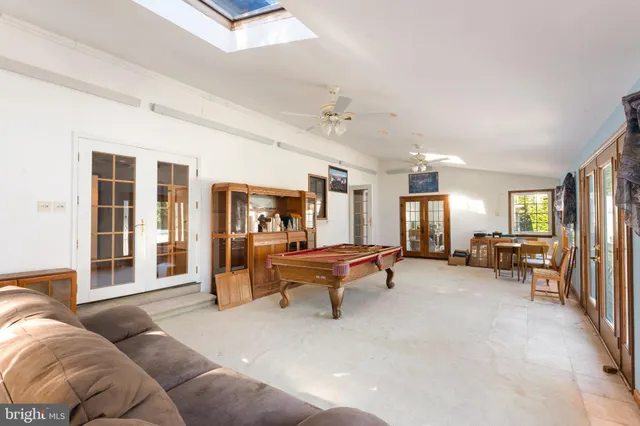 a view of a livingroom with workspace and a window