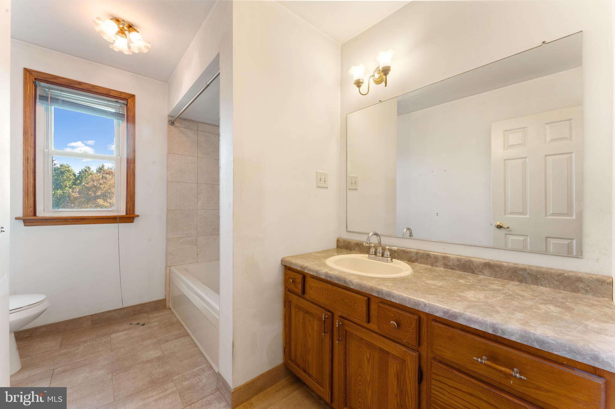 2015 Butternut Drive Huntingdon Valley, PA 19006 - Photo 32 of 40 a bathroom with a granite countertop sink and a mirror