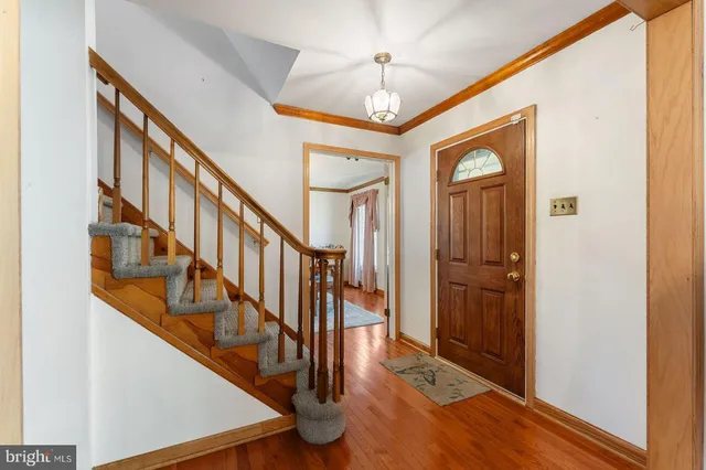 a view of entryway and hall with wooden floor