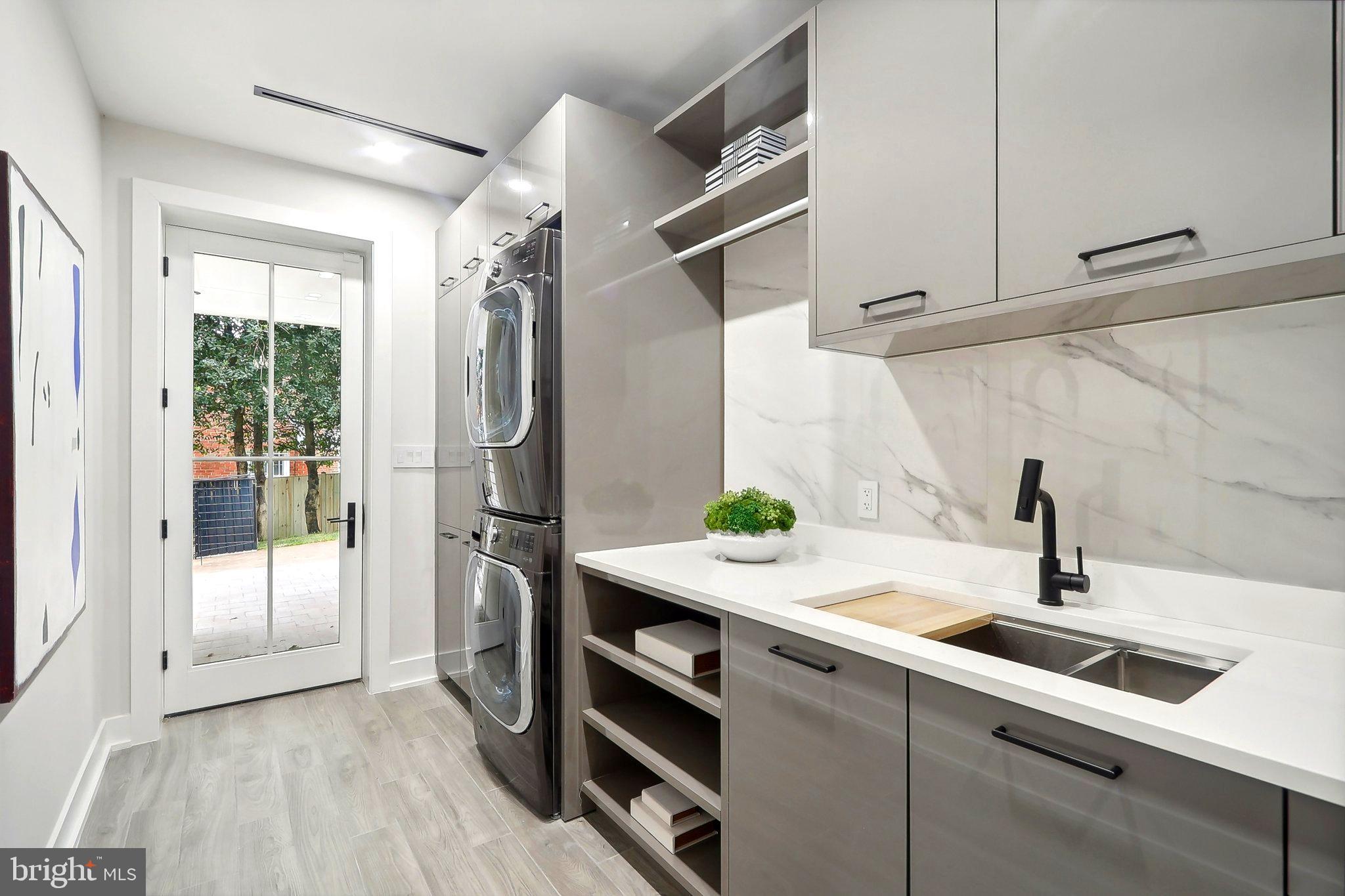 4920 Loughboro Road Northwest Washington, DC 20016 - Photo 36 of 41 a kitchen with stainless steel appliances a sink and a refrigerator
