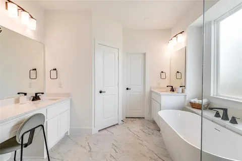 a bathroom with a tub sink and mirror