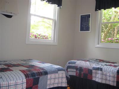 200 Pilgrim Spring Road, Unit B Wellfleet, MA 02667 - Photo 6 of 13 a bedroom with a bed and a window