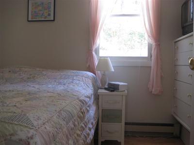 200 Pilgrim Spring Road, Unit B Wellfleet, MA 02667 - Photo 7 of 13 a room with a bed and a window