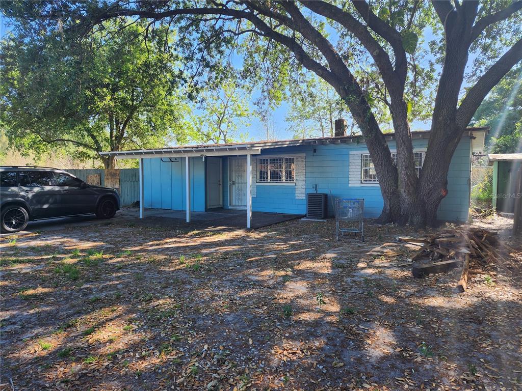 Undisclosed Address Orlando, FL 32809 - Photo 1 of 1 a backyard of a house with barbeque oven and trees