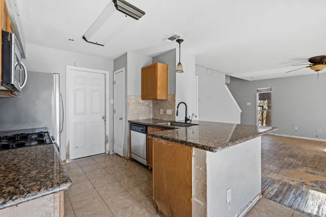 a kitchen with a sink stove and refrigerator