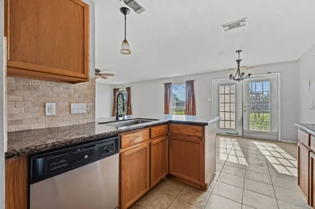 a kitchen with stainless steel appliances granite countertop a sink and stove