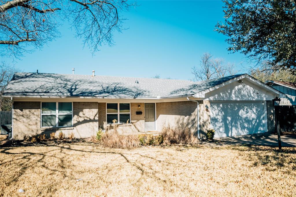 a front view of a house with a yard covered with snow