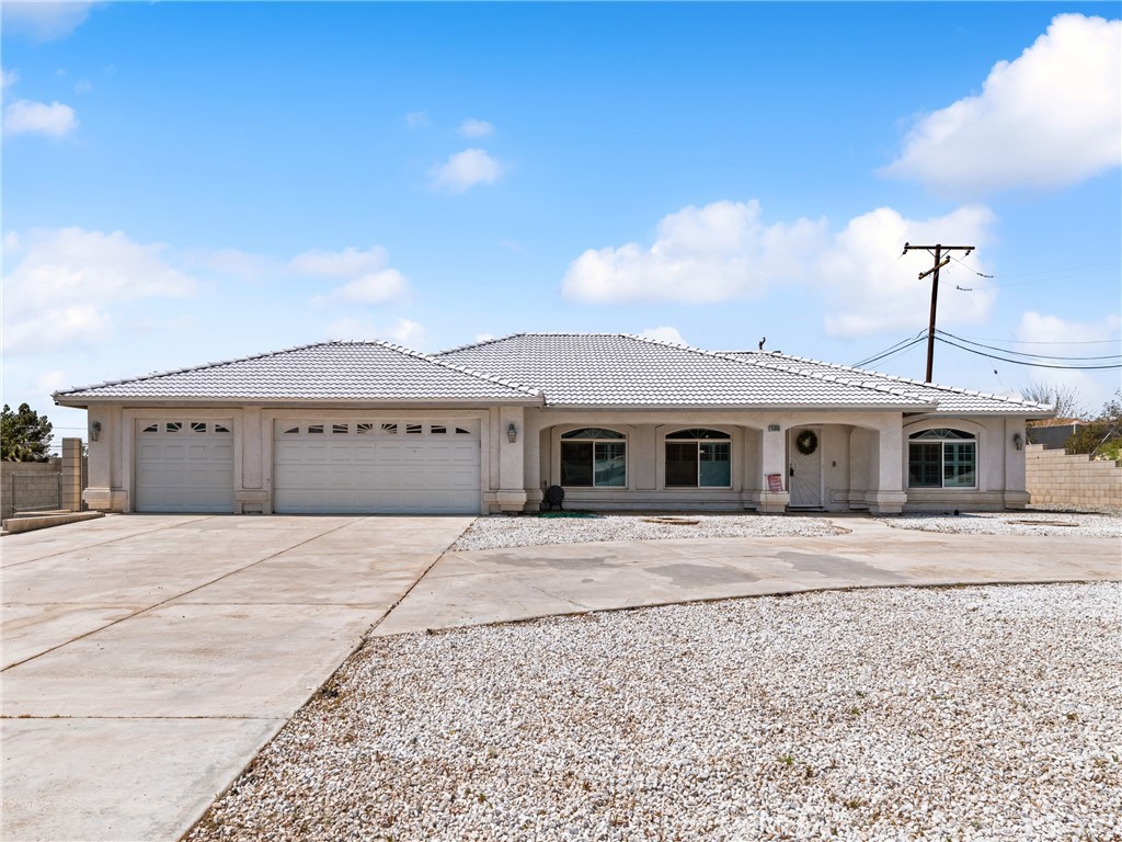 15890 Venango Road Apple Valley, CA 92307 - Photo 1 of 1 a front view of a house with a yard