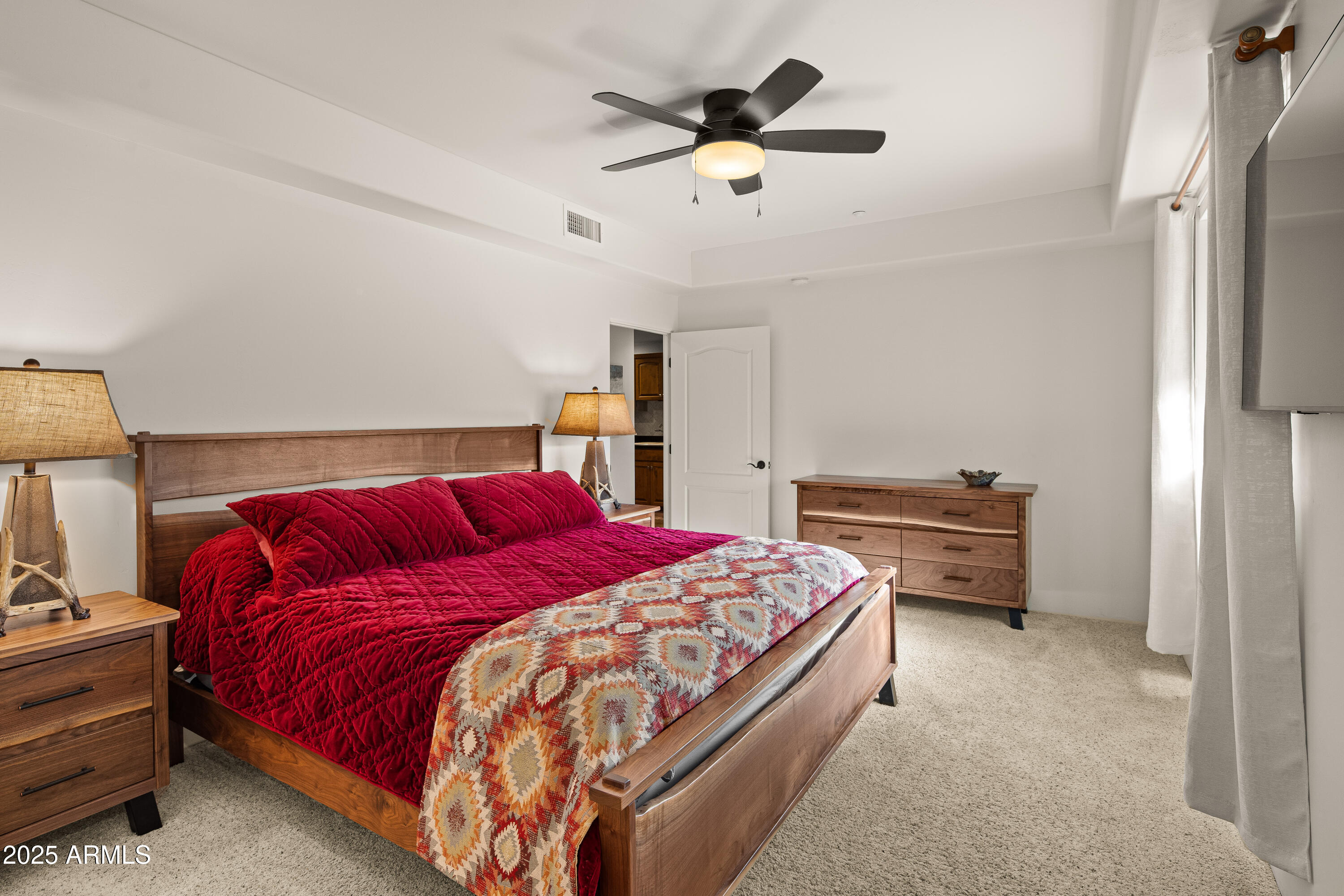 520 Jordan Road, Unit 2 Sedona, AZ 86336 - Photo 12 of 34 a bedroom with a bed and a chandelier