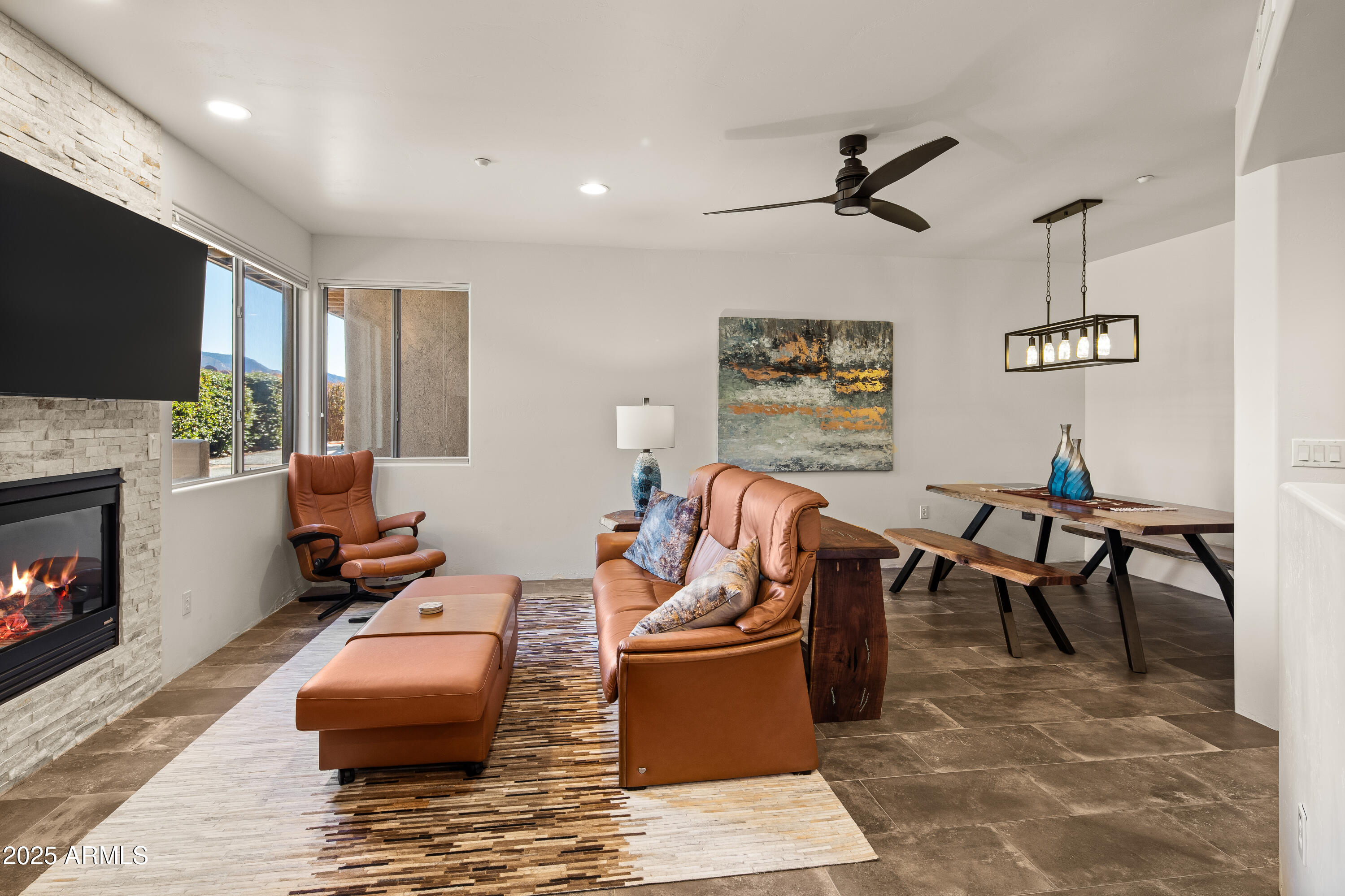 520 Jordan Road, Unit 2 Sedona, AZ 86336 - Photo 3 of 34 a living room with furniture a flat screen tv and a fireplace