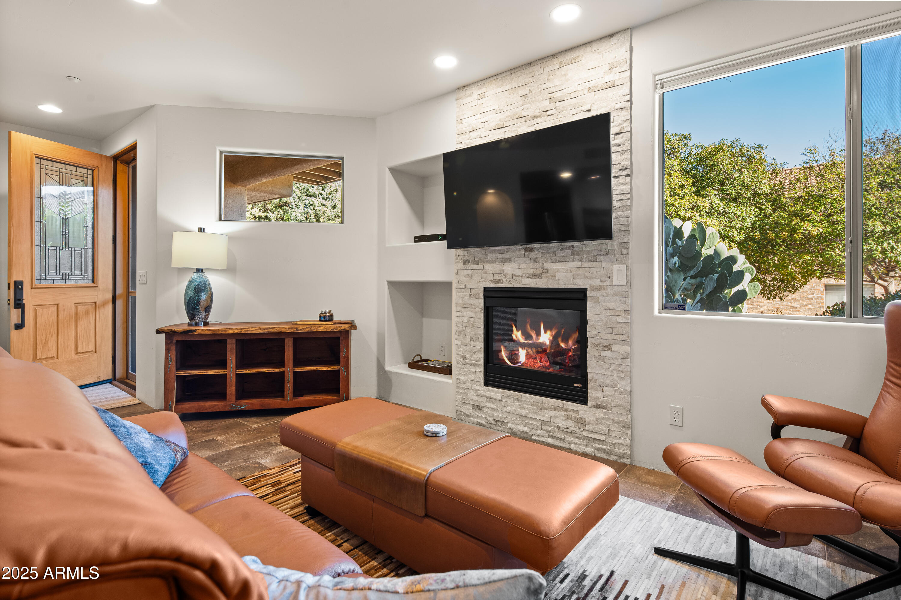 520 Jordan Road, Unit 2 Sedona, AZ 86336 - Photo 4 of 34 a living room with furniture a flat screen tv and a fireplace