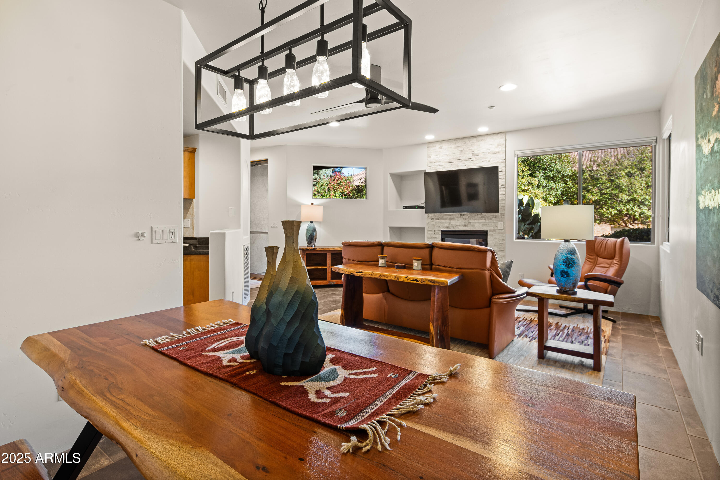 520 Jordan Road, Unit 2 Sedona, AZ 86336 - Photo 7 of 34 a living room with furniture flat screen tv and a large window