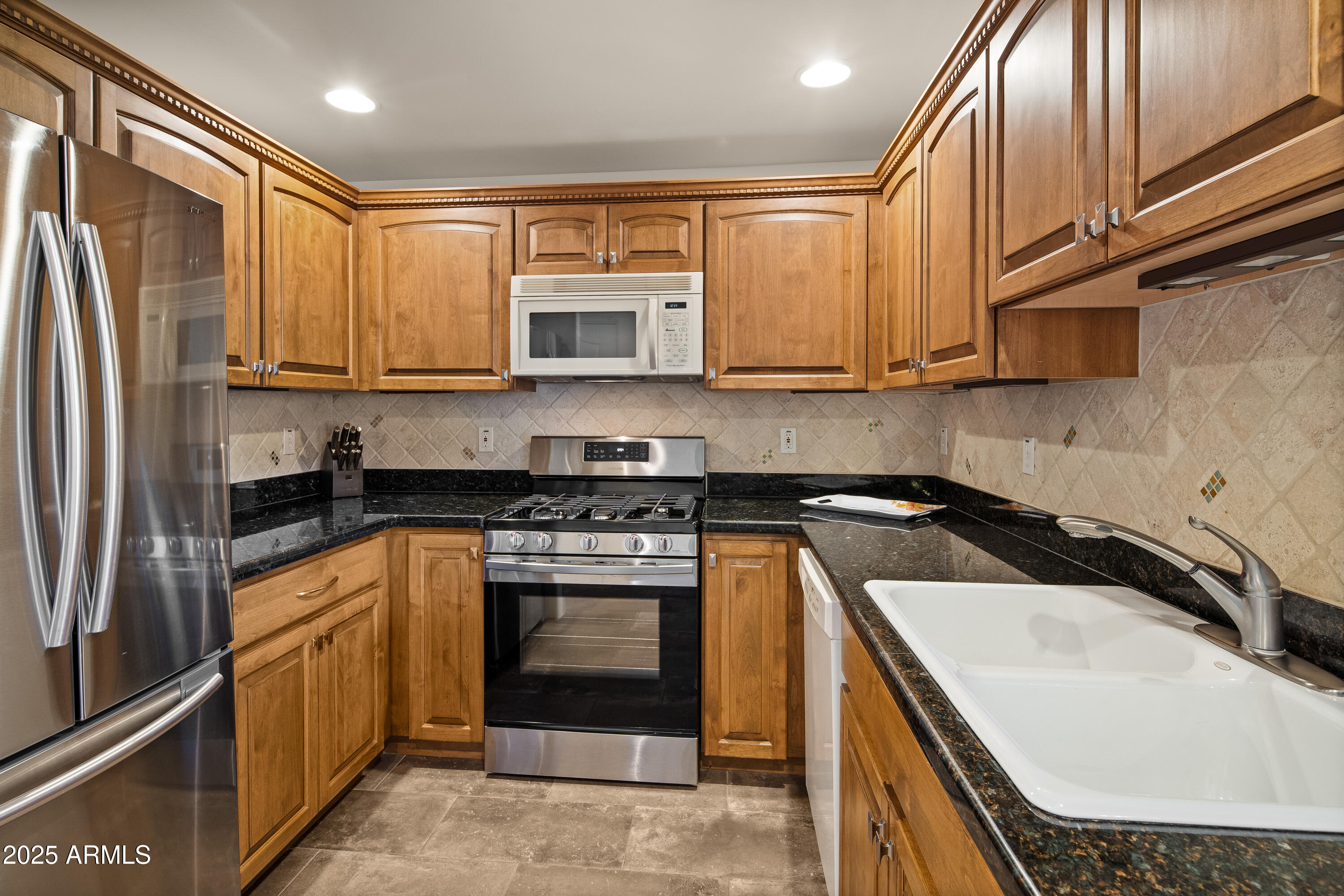 520 Jordan Road, Unit 2 Sedona, AZ 86336 - Photo 9 of 34 a kitchen with stainless steel appliances granite countertop a sink stove and refrigerator