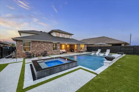 a view of a house with pool and chairs