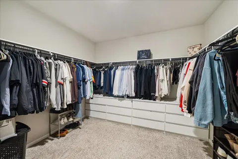 a bedroom with a bed and cabinet