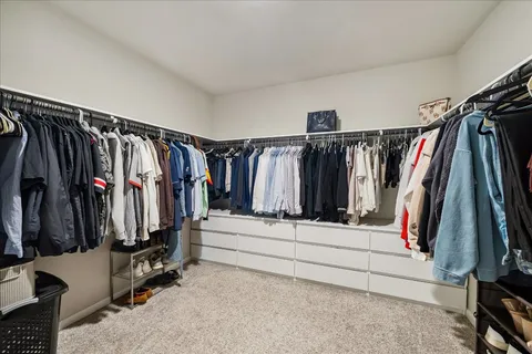 a bedroom with a bed and cabinet