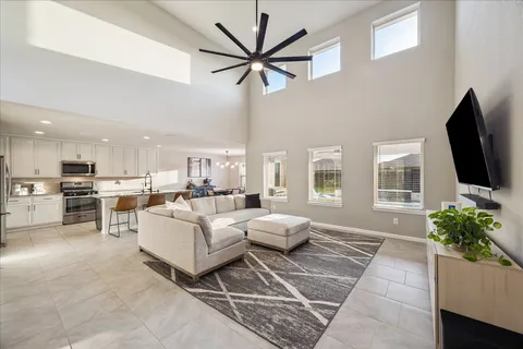 a kitchen with a dining table chairs and wooden floor