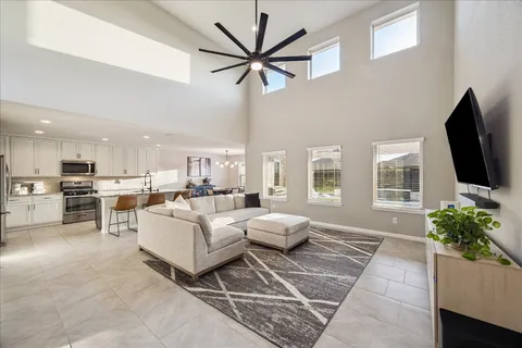 a kitchen with a dining table chairs and wooden floor