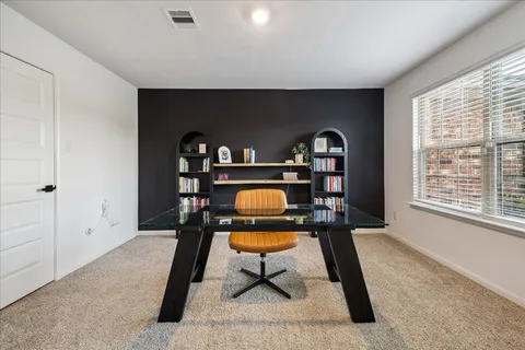 a living room with furniture a rug and a chandelier