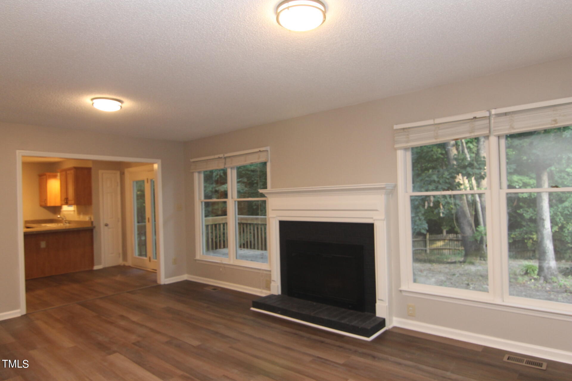 3313 Singleleaf Lane Raleigh, NC 27616 - Photo 5 of 25 a view of an empty room with wooden floor and a window