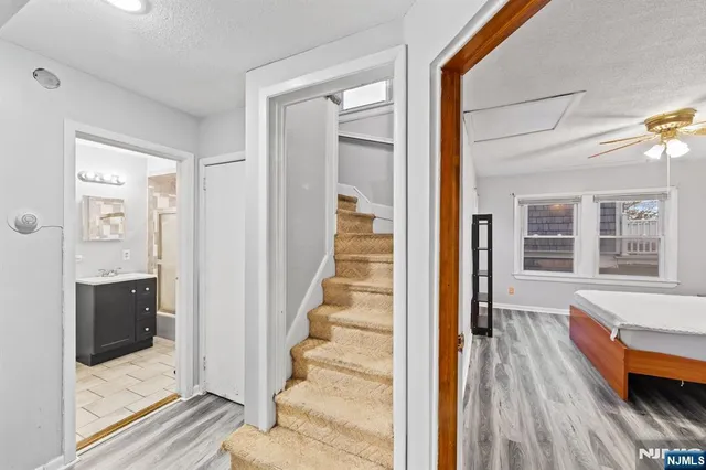 a view of a bedroom with wooden floor and windows
