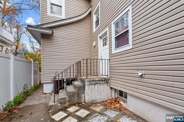 a view of a patio with table and chairs and wooden fence
