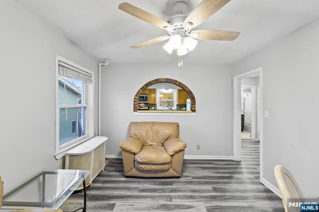 a view of a dining room with furniture and a chandelier