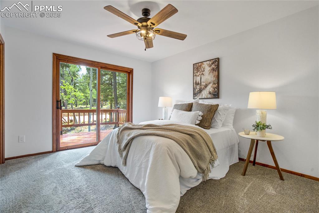57 Aspen Circle Divide, CO 80814 - Photo 15 of 50 a spacious bedroom with a bed and a lamp