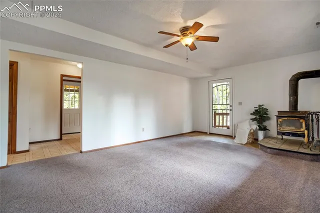 a view of a livingroom with a window and a ceiling fan