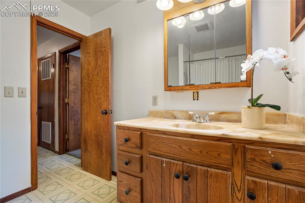 57 Aspen Circle Divide, CO 80814 - Photo 35 of 50 a bathroom with a granite countertop sink and a mirror
