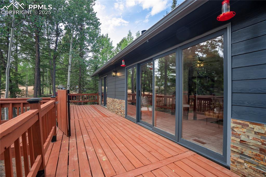 57 Aspen Circle Divide, CO 80814 - Photo 4 of 50 a balcony with wooden floor and outdoor space