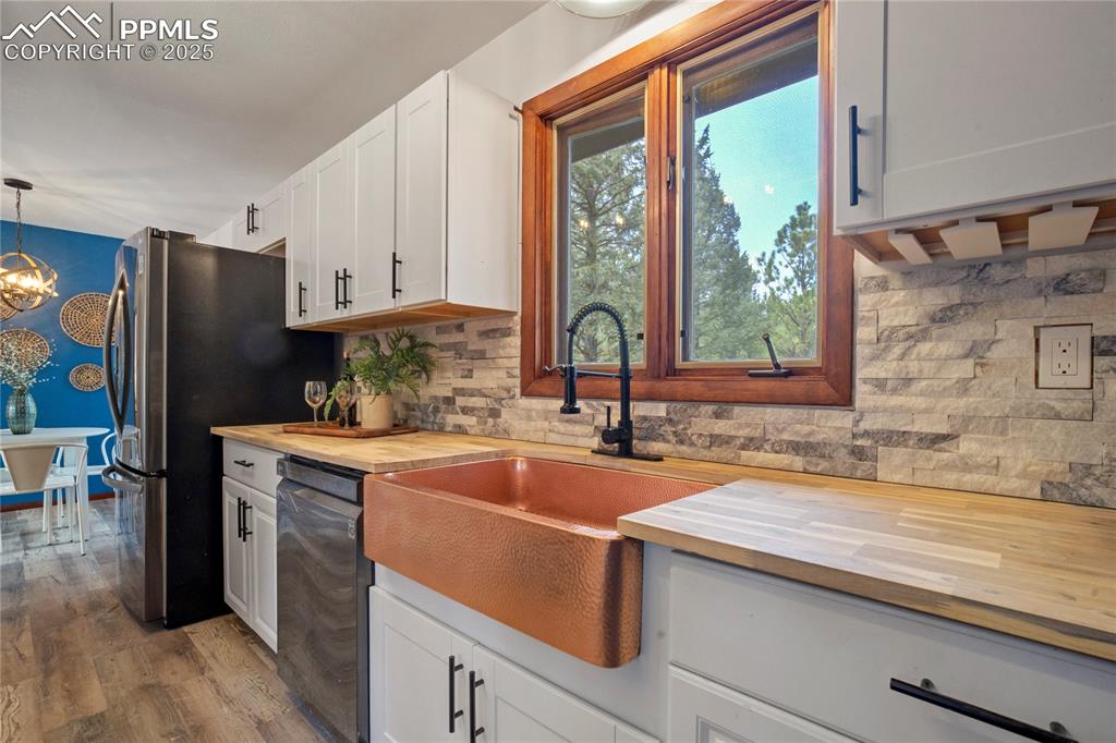 57 Aspen Circle Divide, CO 80814 - Photo 7 of 50 a kitchen with stainless steel appliances granite countertop a sink a stove and a refrigerator