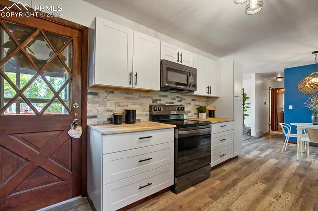 a kitchen with stainless steel appliances kitchen island granite countertop a stove a sink and a microwave