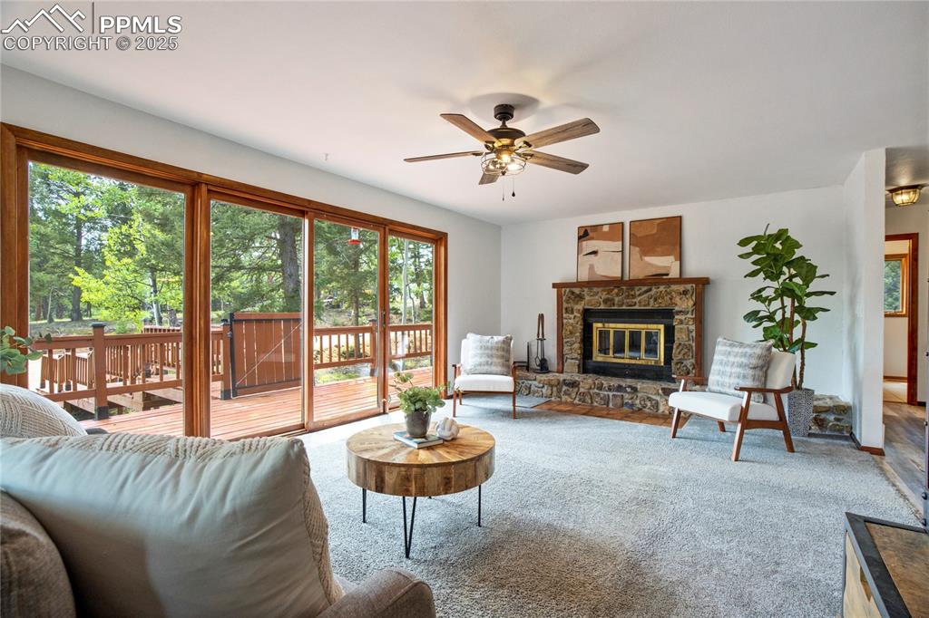 57 Aspen Circle Divide, CO 80814 - Photo 10 of 50 a living room with furniture a fireplace and a large window
