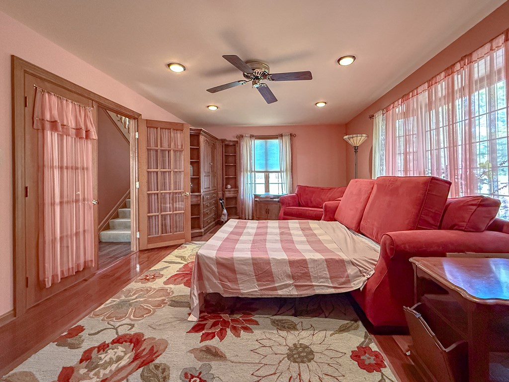 13581 Solitude Trail Machipongo, VA 23405 - Photo 22 of 51 a living room with furniture a rug and a chandelier