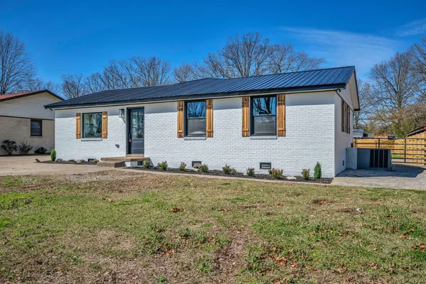 a kitchen with a refrigerator sink and cabinets