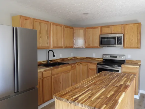 a kitchen with a sink dishwasher and cabinets