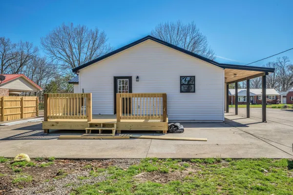 an empty room with a ceiling fan and a window