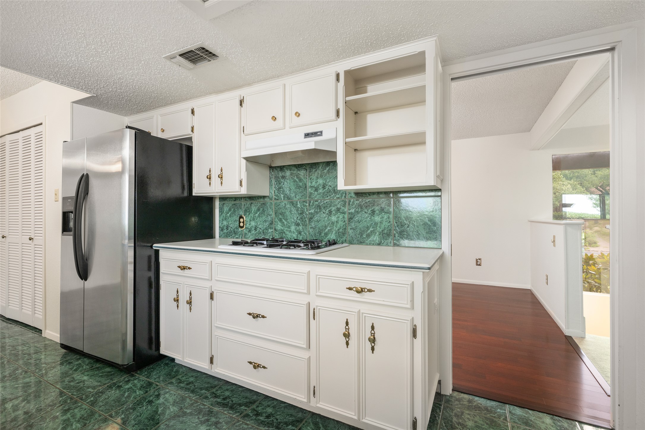 5319 Musket Ridge Austin, TX 78759 - Photo 15 of 39 Bright white cabinetry and a built-in range elevate this efficient kitchen space.