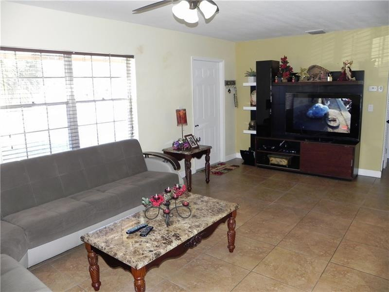 9650 Colorado Court Boca Raton, FL 33434 - Photo 6 of 14 a living room with furniture and a flat screen tv